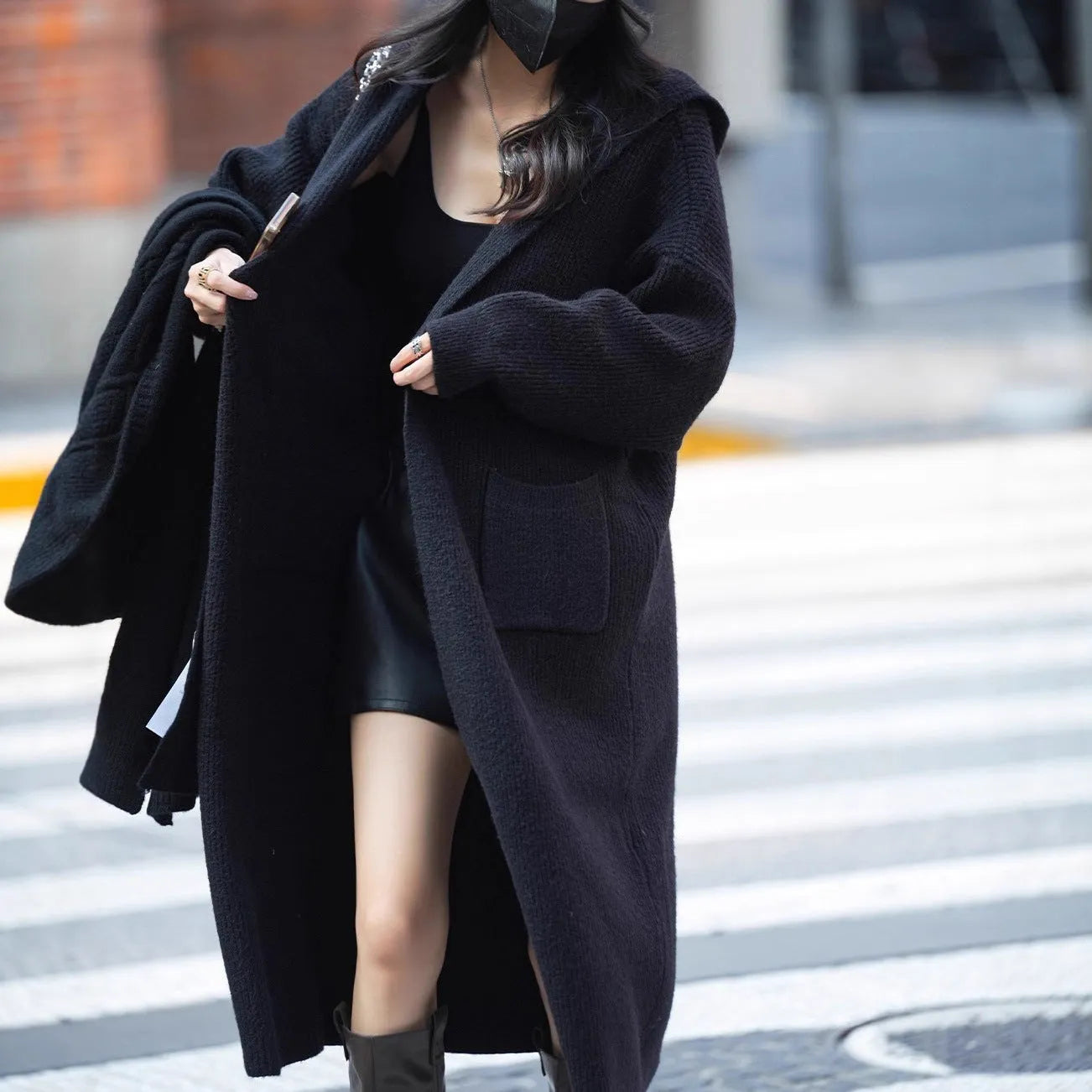 Long grey hooded cardigan sweater with a trench coat style, made from a wool and cashmere blend.