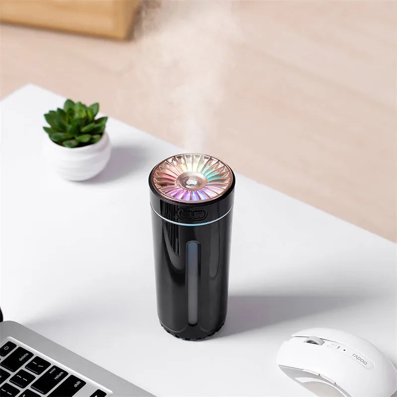 Black USB car humidifier with LED lights placed in vehicle cup holder showing mist output
