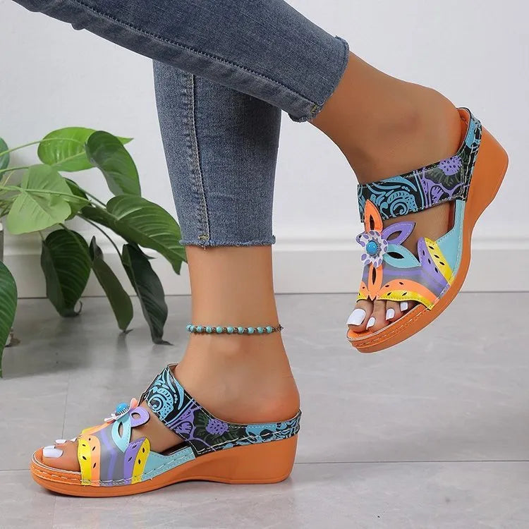 Colourful ethnic slope heel slippers for women with totem design on a cowhide upper.