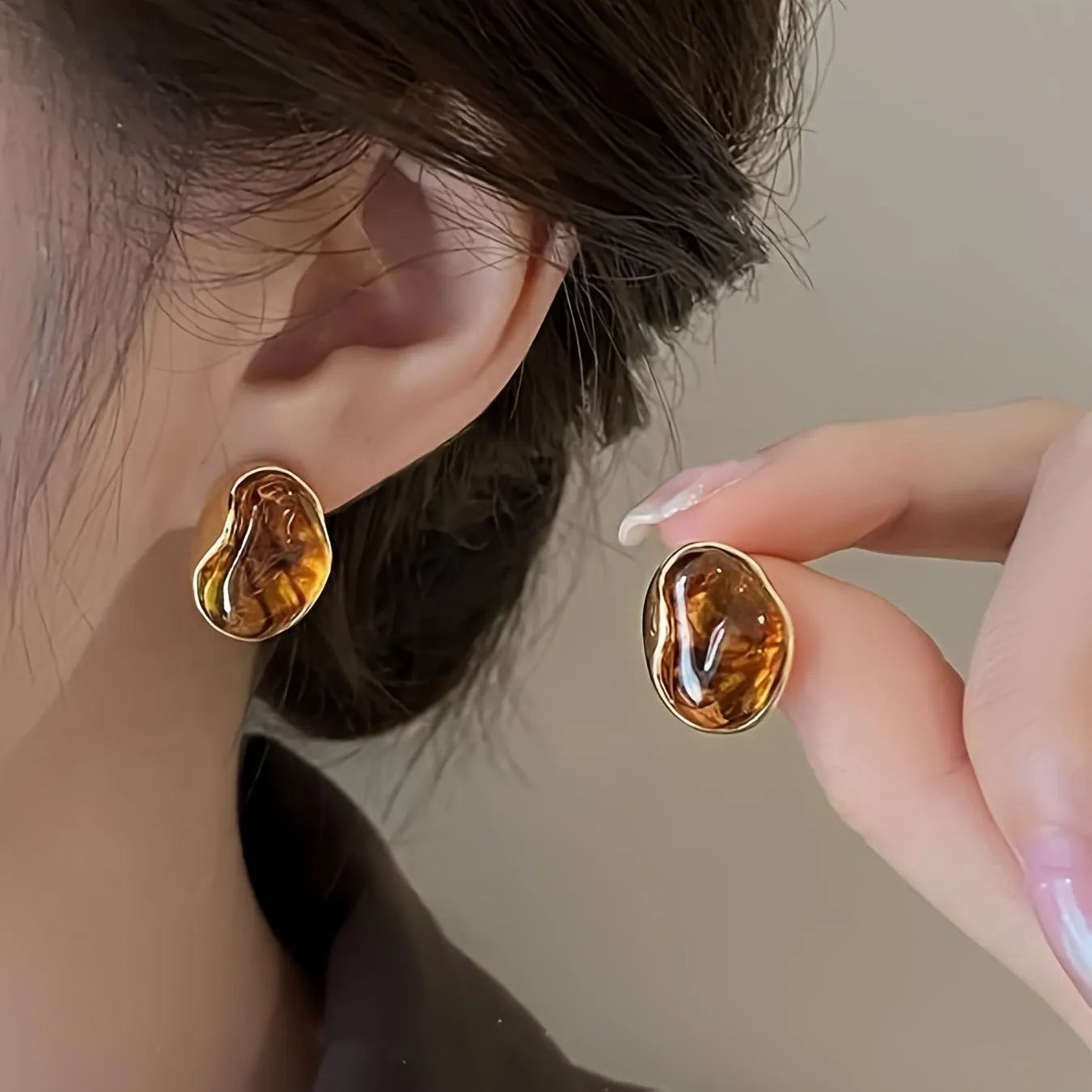 Three pairs of geometric earrings with tassel detailing in different styles: round, irregular, and water drop shapes.