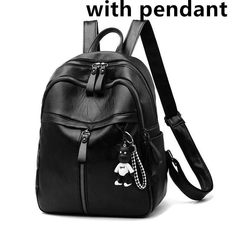 Black soft surface PU leather backpack with double straps, shown with a luggage strap accessory.