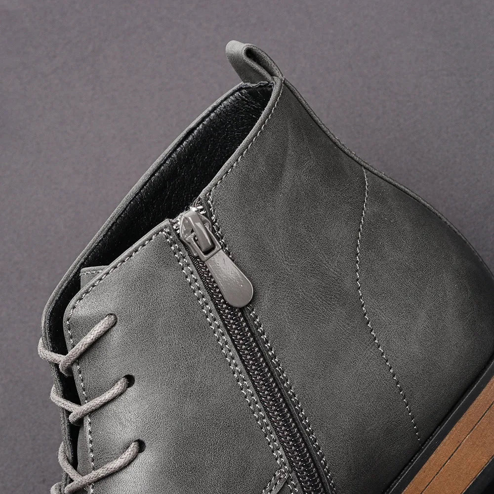 Men's brown Chelsea boot with a side zipper, round toe, and low wooden sole.