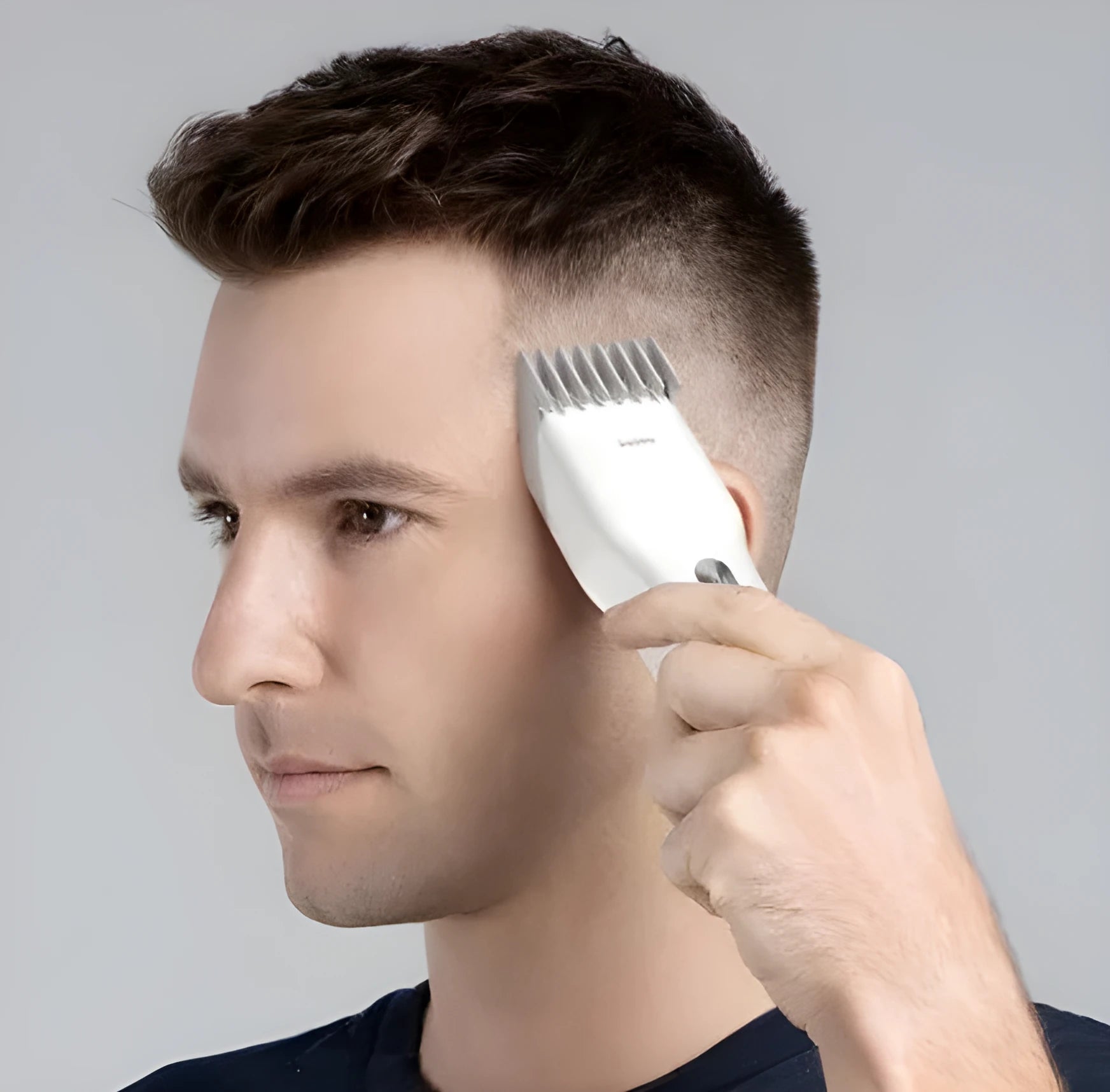 Black cordless men's hair clipper with ceramic blades and adjustable length comb
