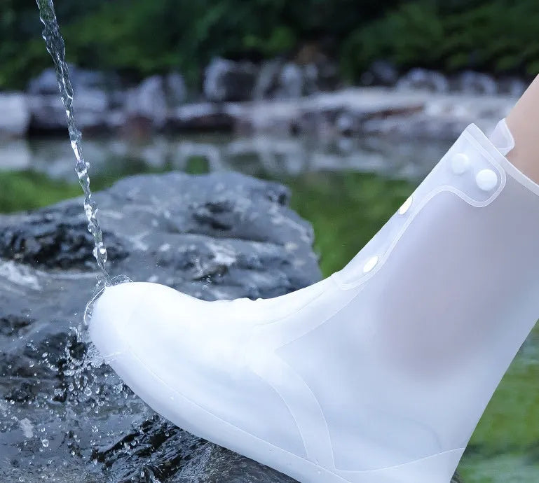 White high top PVC reusable water resistant shoe covers for women with anti-skid soles.