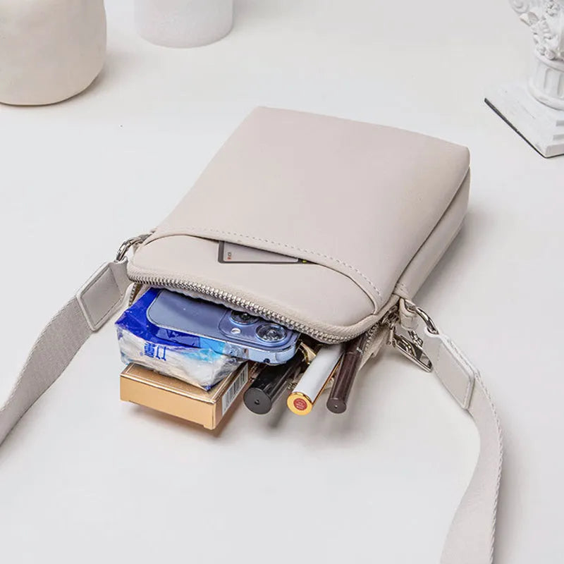 Solid colour crossbody phone bag for women in black, made from PU with an adjustable strap.