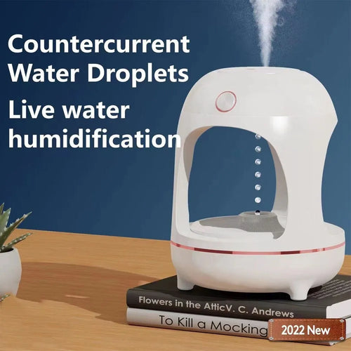 Rose gold and white levitating water drops humidifier with LED light on desk