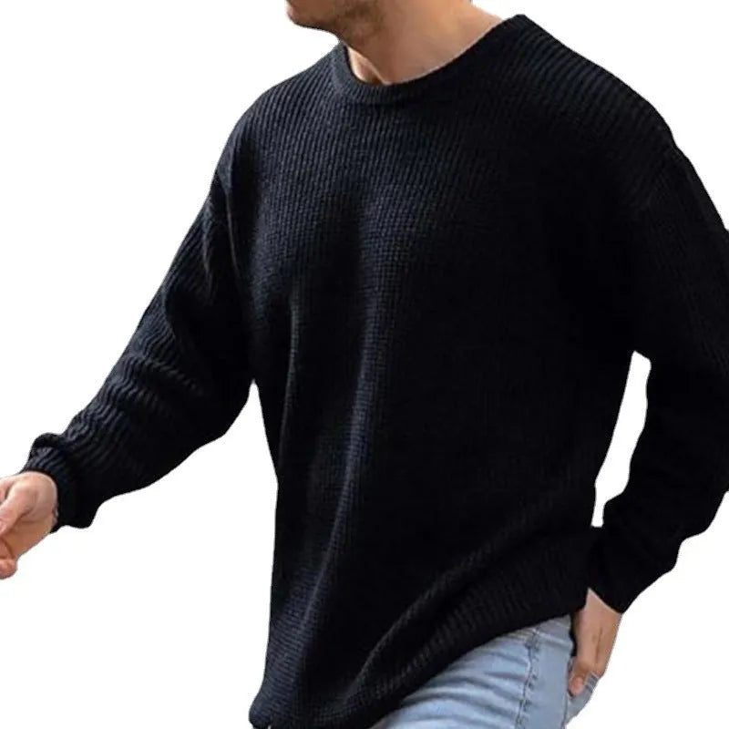 Men's solid colour round neck long sleeve acrylic sweater in black, folded flat on a white background
