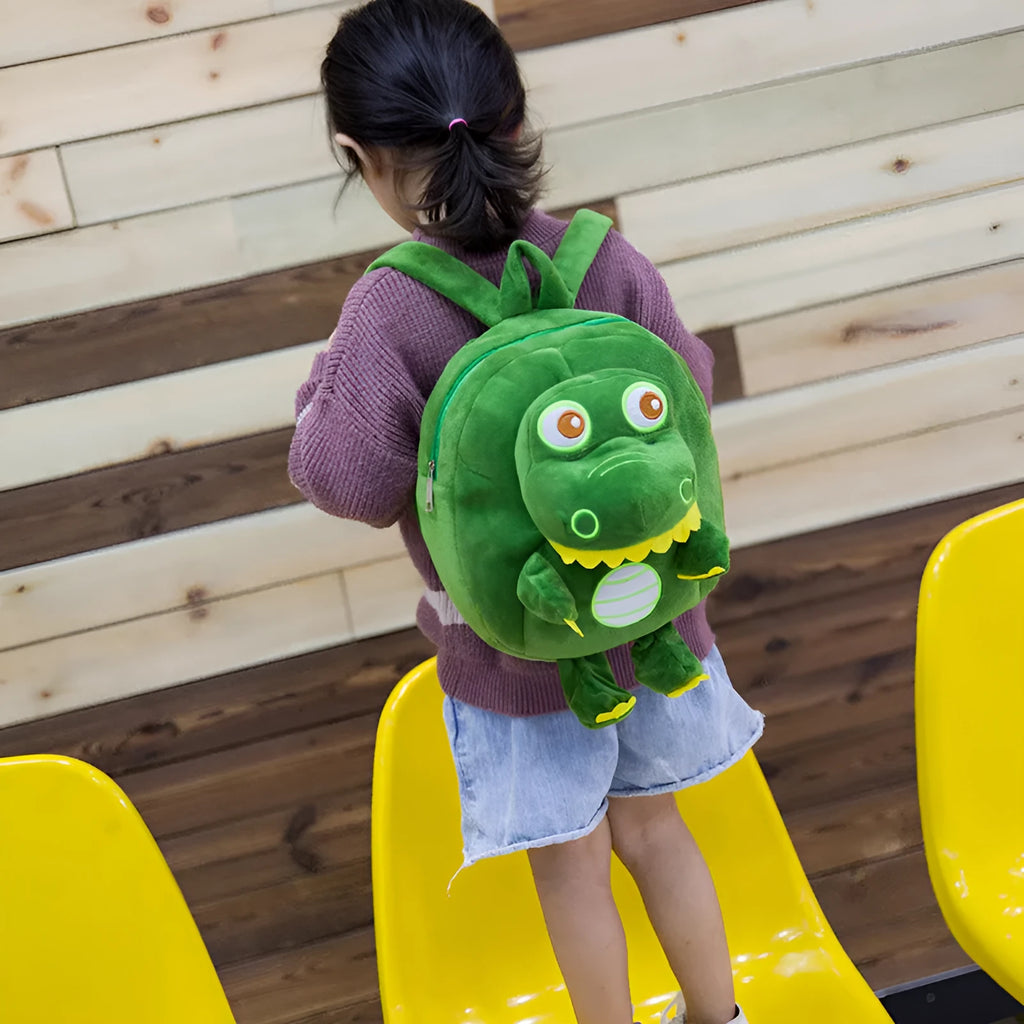 Dinosaur plush backpack for children with embroidered design in blue colour showing soft handle and animal pattern
