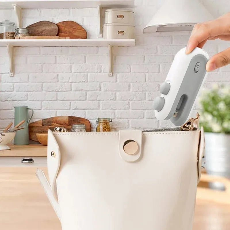 Blue handheld USB heat sealer with magnetic back and cutter blade for sealing chip bags