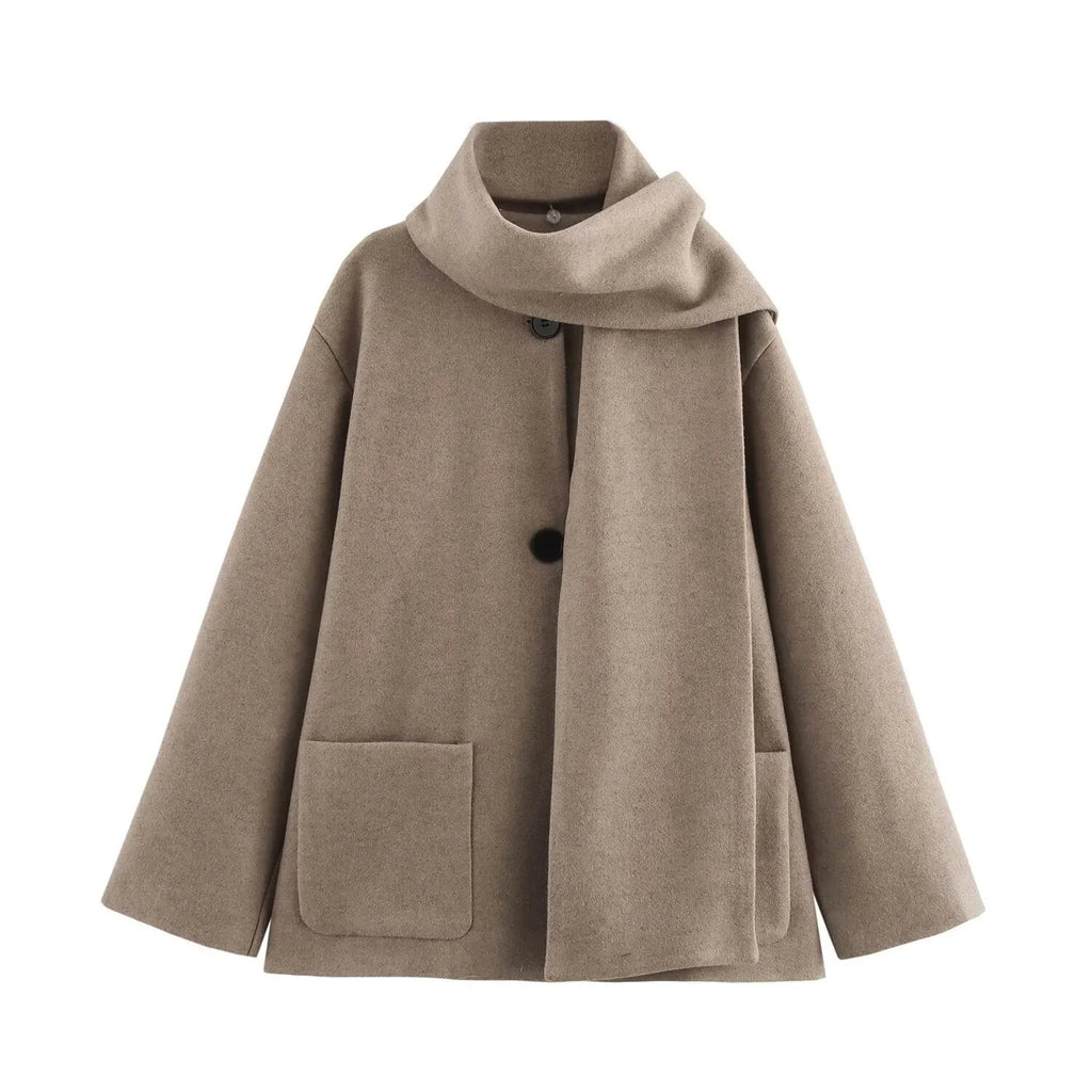 Women's long grey polyester overcoat with artificial fur collar on a model, showcasing street fashion style.