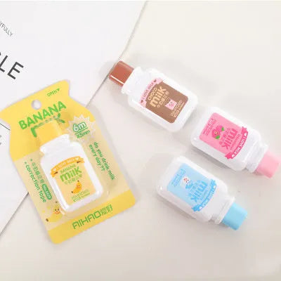 A cute, patterned bottle-shaped correction tape dispenser with a curved design, shown on a paper surface.