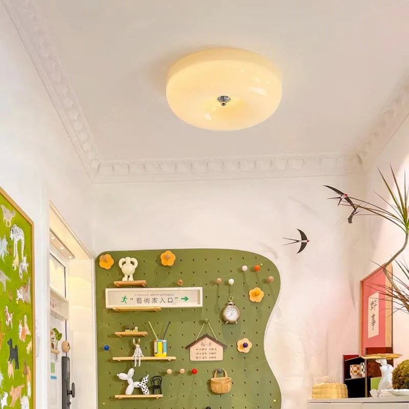 American style cream coloured bedroom ceiling light with a remote control on a white background.