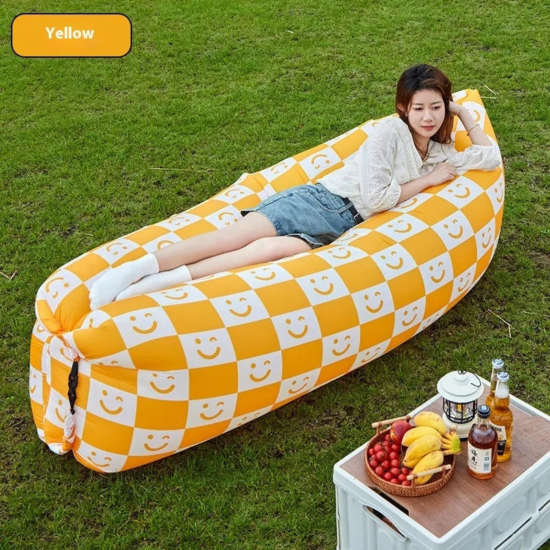 Yellow smiling face tip inflatable portable outdoor sofa seat on grass