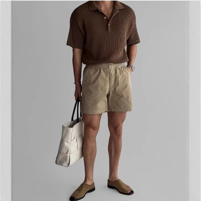 A pair of loose-fit cotton sports shorts in khaki colour on a mannequin, showing the casual summer style.