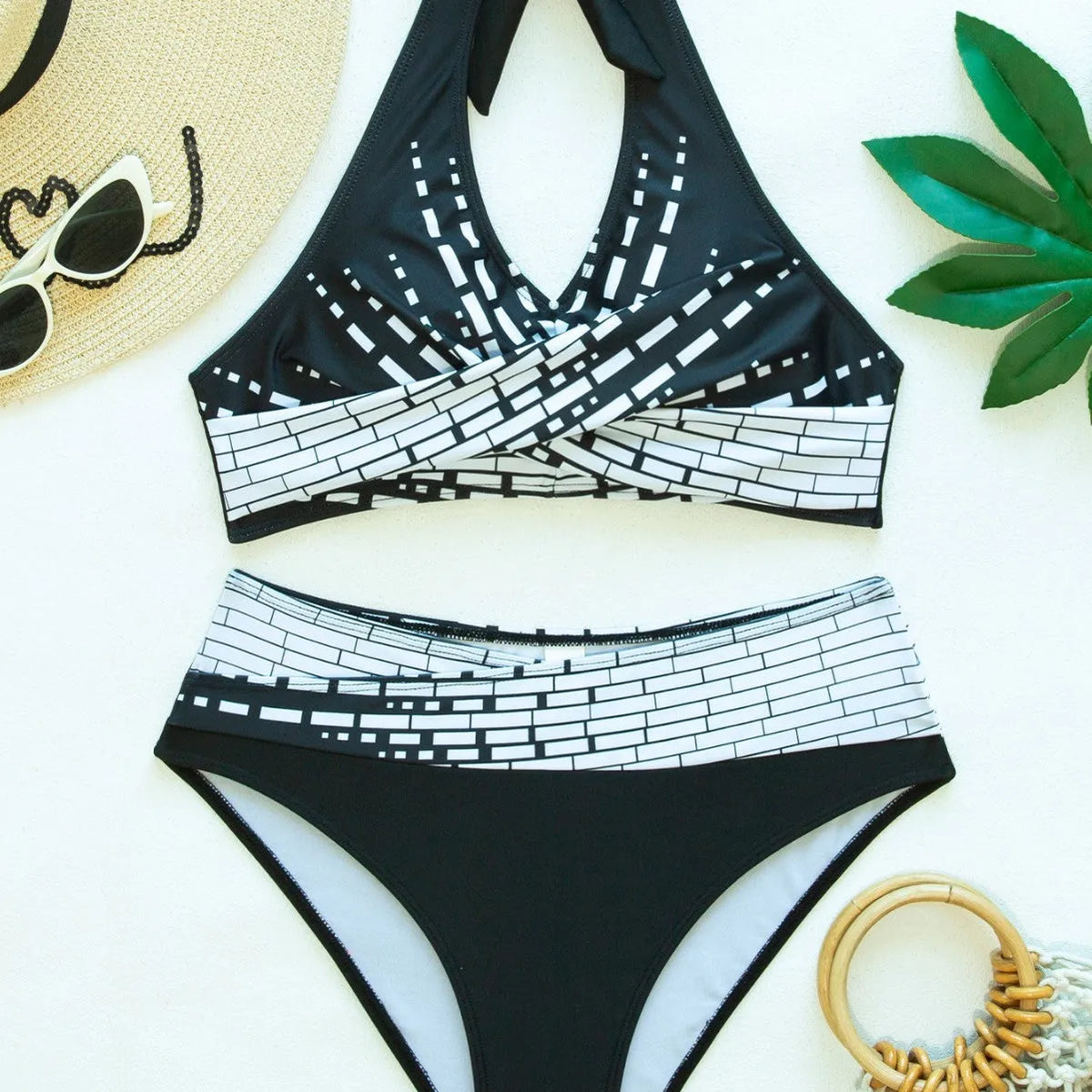 Women's two-piece swimsuit with halter high chest top, briefs-style bottoms, and matching shorts in contrast colour