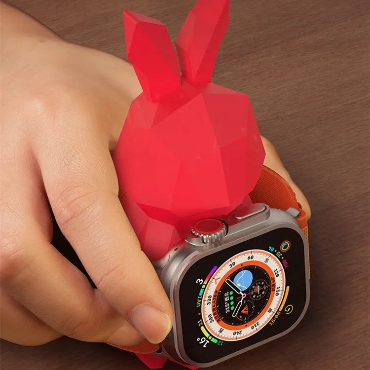 Rabbit-shaped silicone desk charger bracket in white with wrist strap holding a charging cable