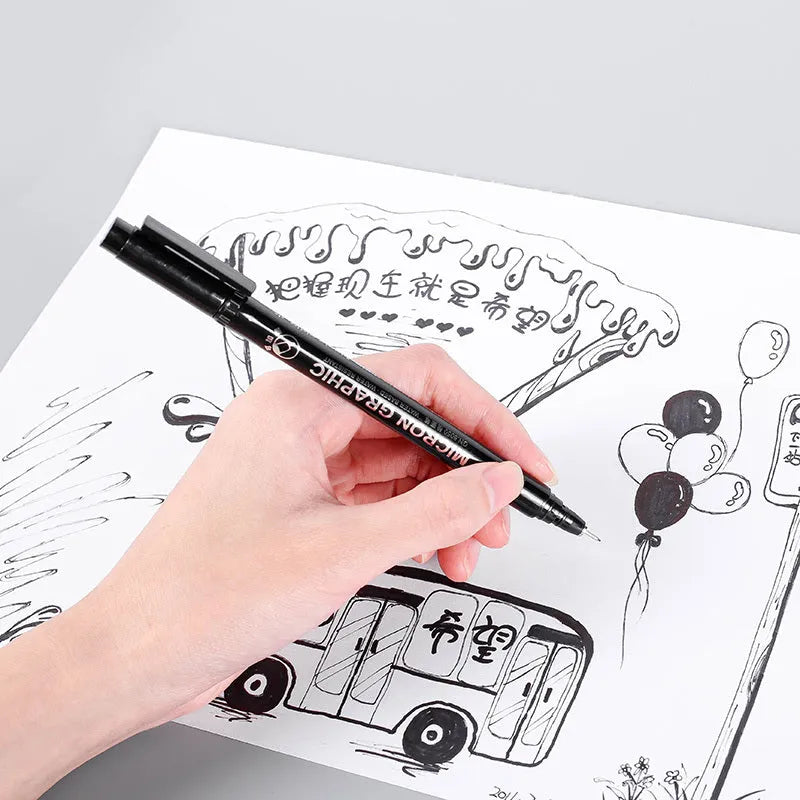 Set of 12 black comic drawing pens with various nib sizes stored in a fabric organiser bag.