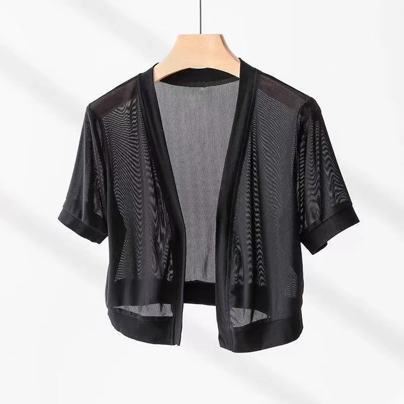 Women's black long sleeve shirt with an irregular collar and a tie closure at the neck.