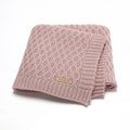 Solid colour infant hug blanket with a three-dimensional lines texture, shown in a soft pink shade.