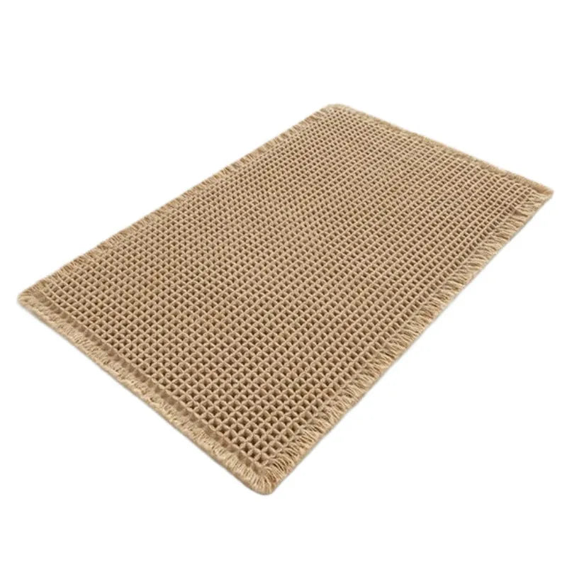 Square checkered pattern non-slip bathroom carpet on tiled floor in beige colour.