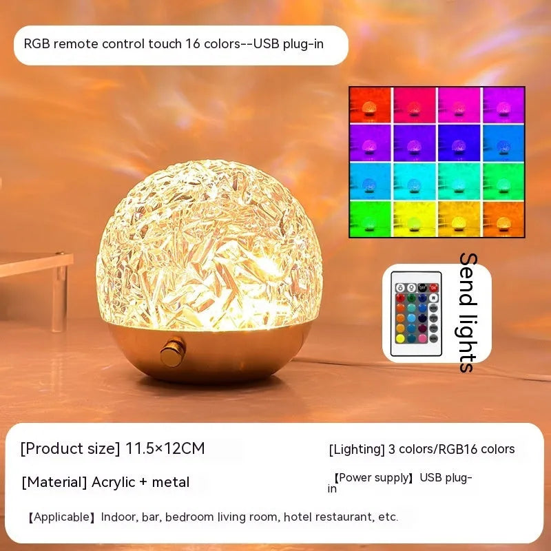 Water ripple projector night light with crystal-like acrylic body and colourful ripple patterns on a bedside table