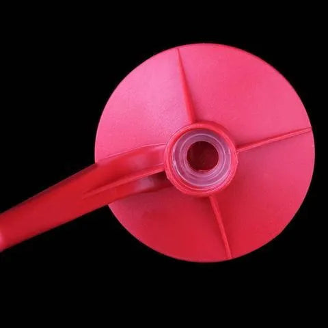Red plastic Magic Tap soda drink dispenser attached to an inverted 2-litre bottle.