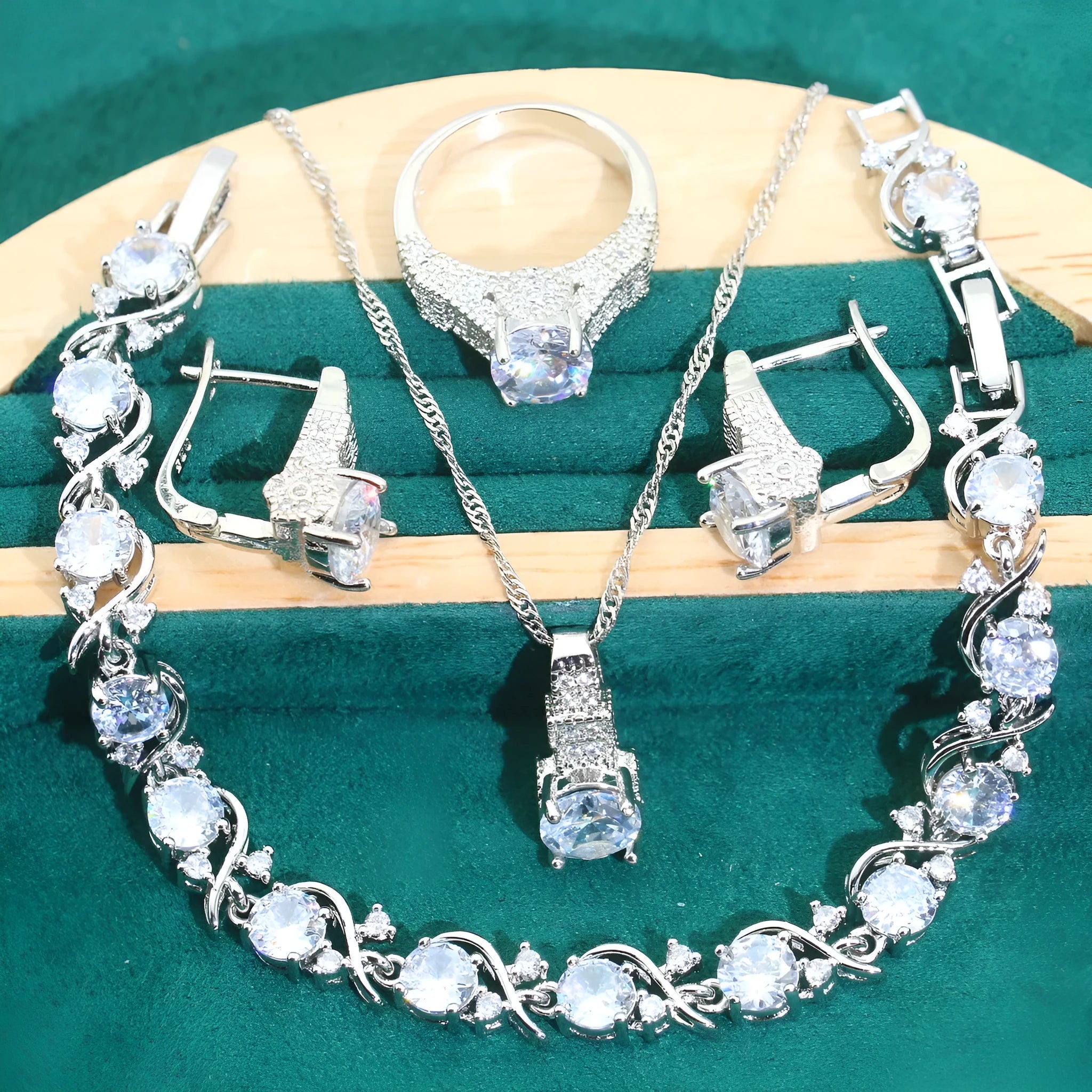 Bridal zircon and alloy four-piece jewellery set showing necklace, earrings, bracelet, and ring in white colour