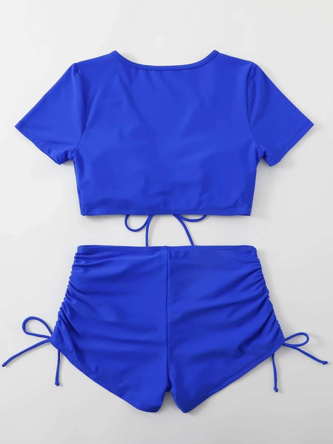 Women's dark green lace-up swimsuit top with matching shorts on a mannequin.