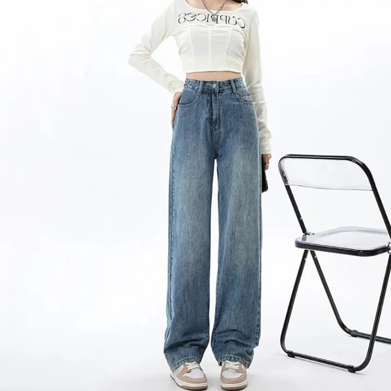 Women's retro blue high-waist wide-leg denim jeans on a hanger, showing the straight leg cut and front pockets.