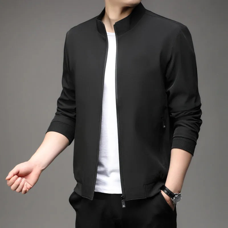 Man wearing a loose-fit grey Korean-style lapel jacket with zipper pockets.