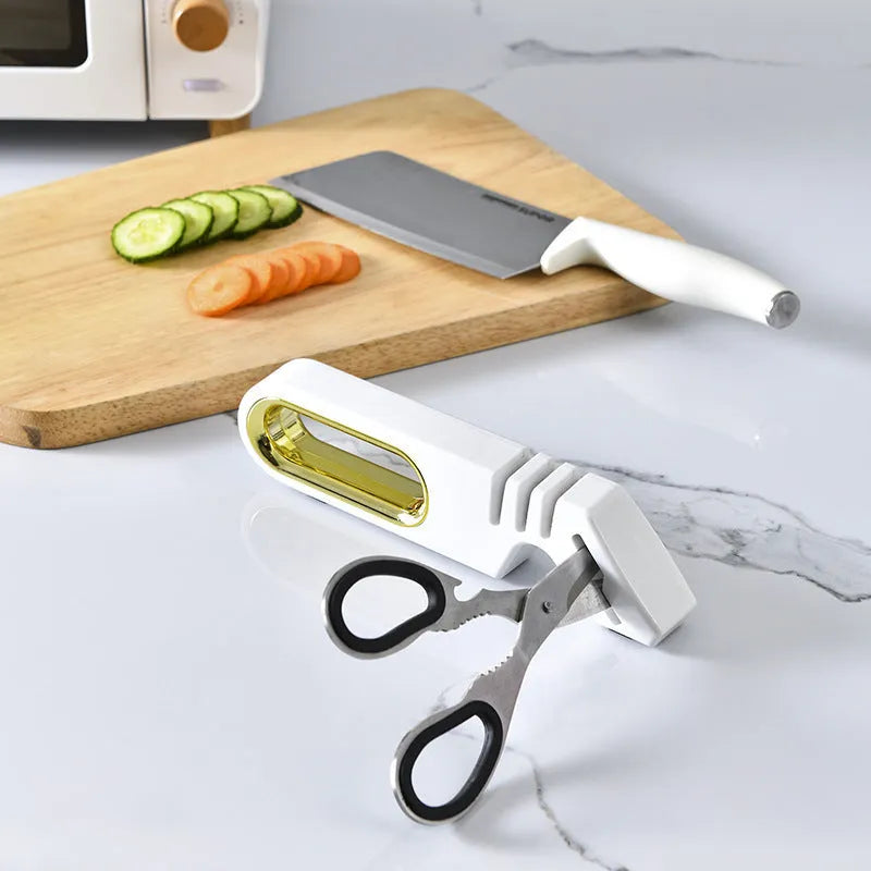Four-in-one stone manual grinder for sharpening kitchen knives in pearl white colour, with ceramic and diamond stages visible