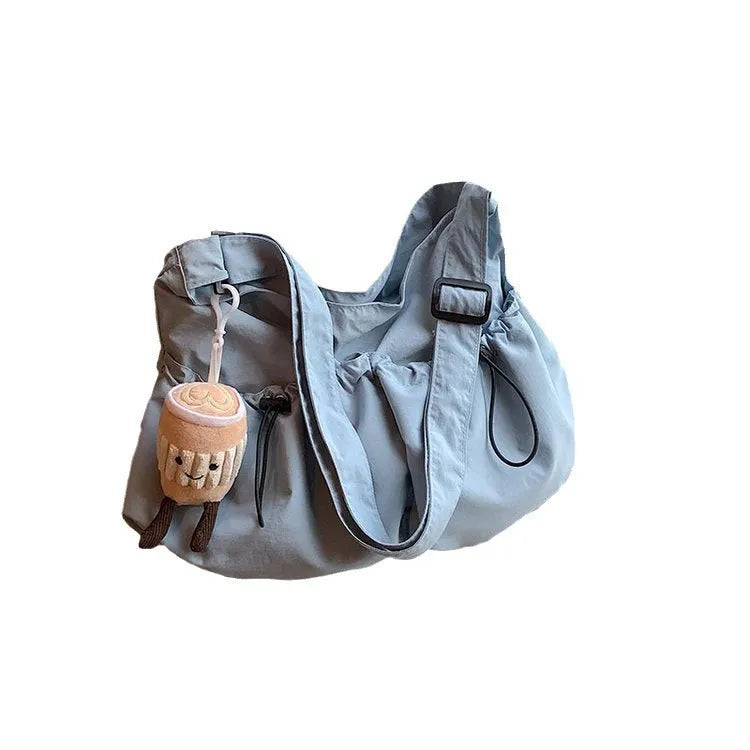 Foldable pleated polyester crossbody bag in street style, showing split pockets and a green colour option.