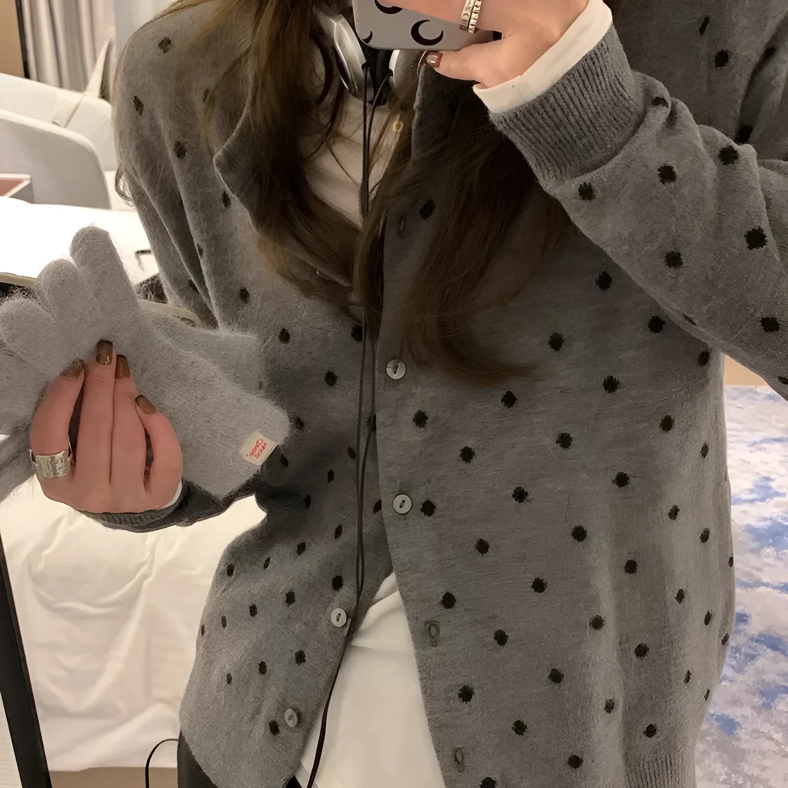 Grey dot crochet pattern on a loose-fit black women's viscose knitted cardigan.