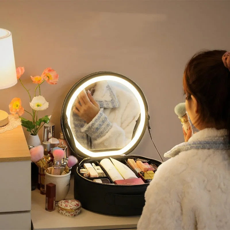 Round black smart LED makeup bag with lighted mirror open, showing internal partitions.