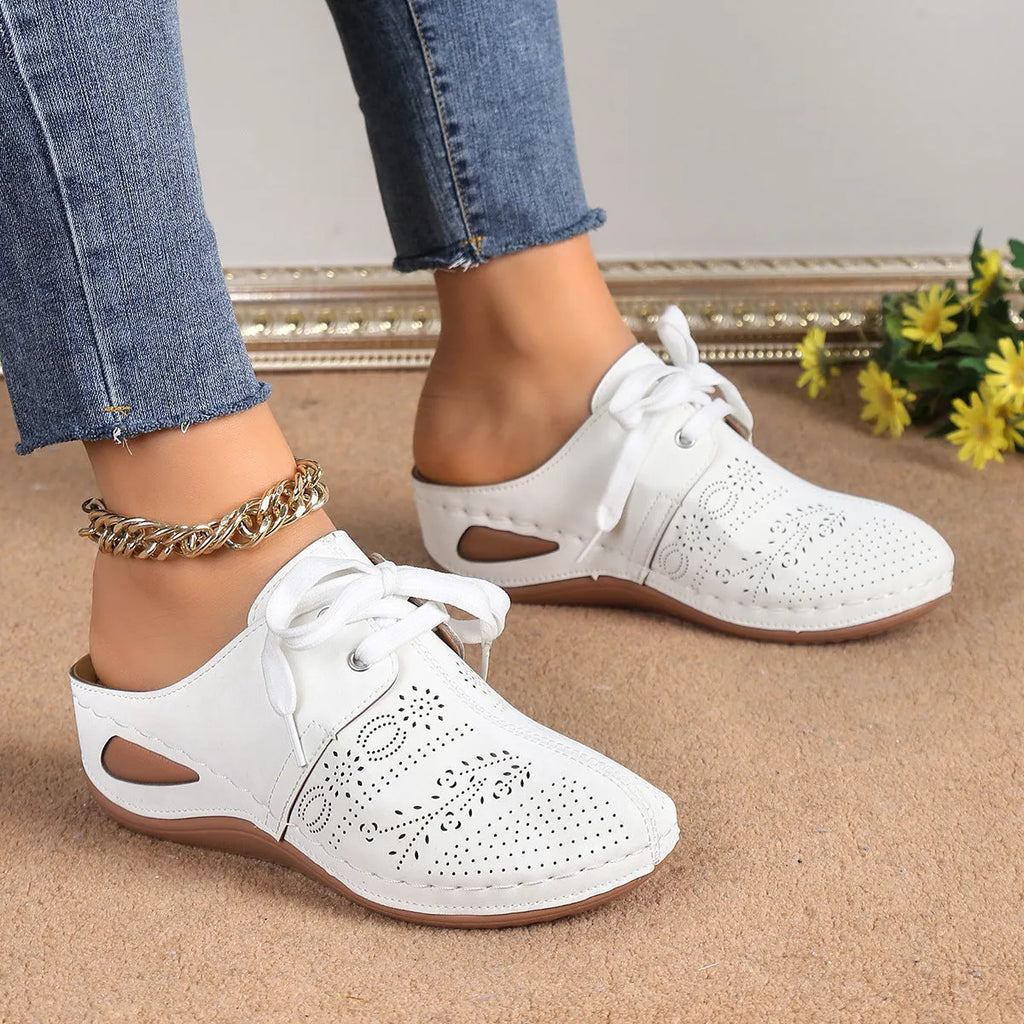Women's black suede lace-up wedge sandals with a hollow-out design and rubber sole.