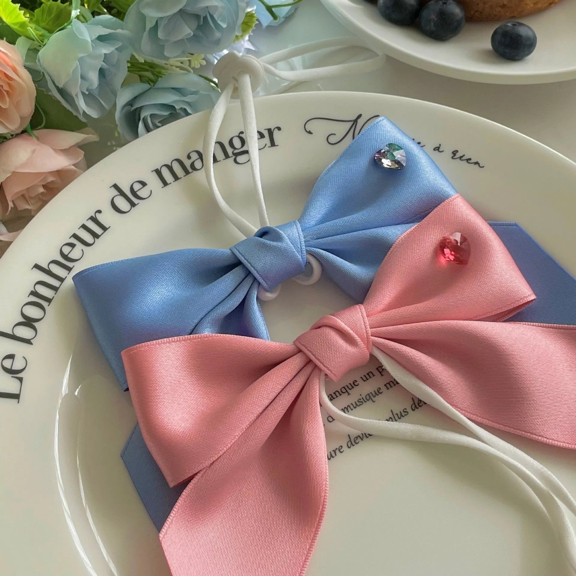 Blue adjustable dog hair band headband with a princess-style bow on a small dog.