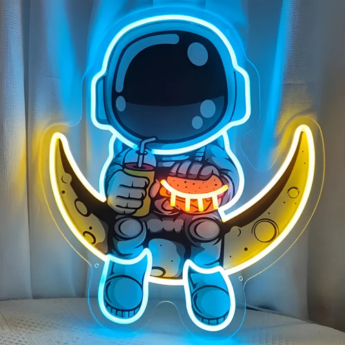 Blue and yellow astronaut-shaped neon light sign mounted on a wall