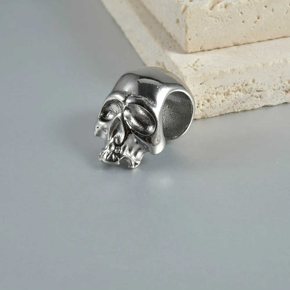 Stainless steel hollow skull and Buddha geometric earrings in electroplated colours.