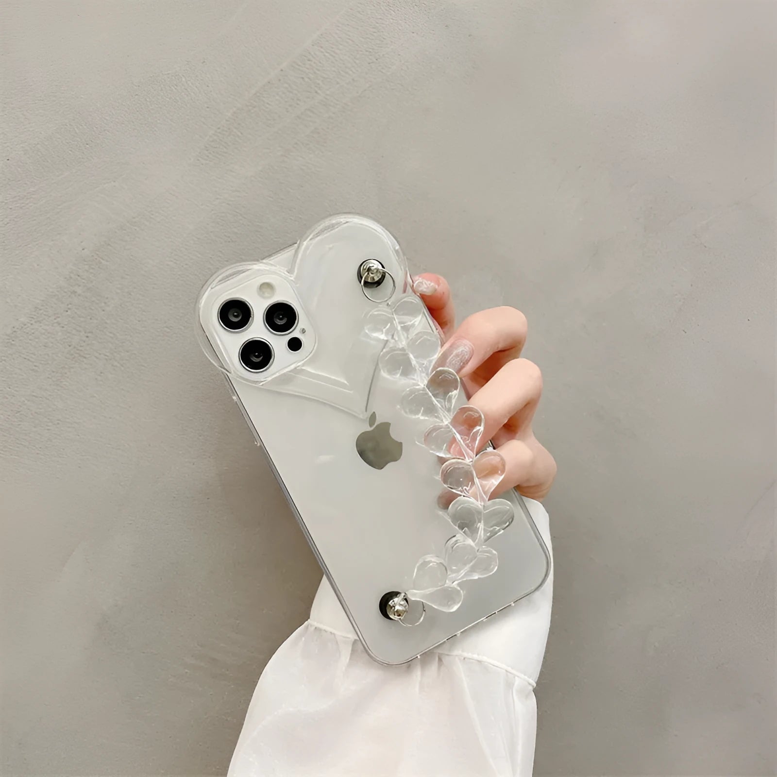Transparent iPhone case with a love heart and bracelet chain design on a soft TPU background.