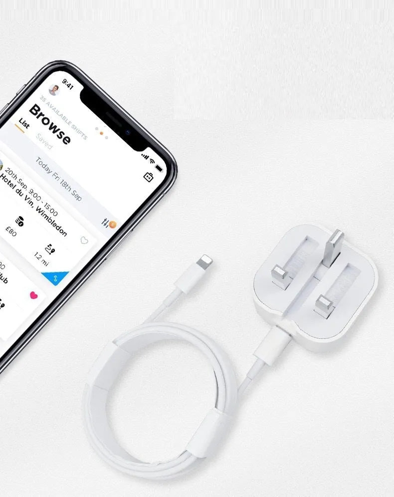 White 20W USB-C Power Delivery fast charger with British plug and coiled USB-C cable.