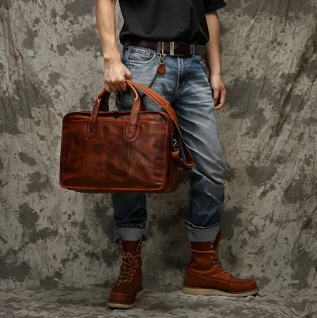Brown vintage leather men's briefcase showing internal organiser pockets and laptop sleeve.