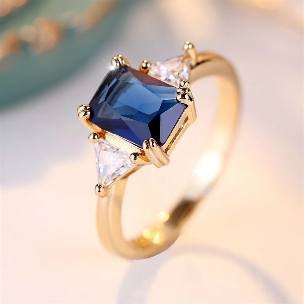 Copper rectangular fashion ring for women in gold sapphire blue colour