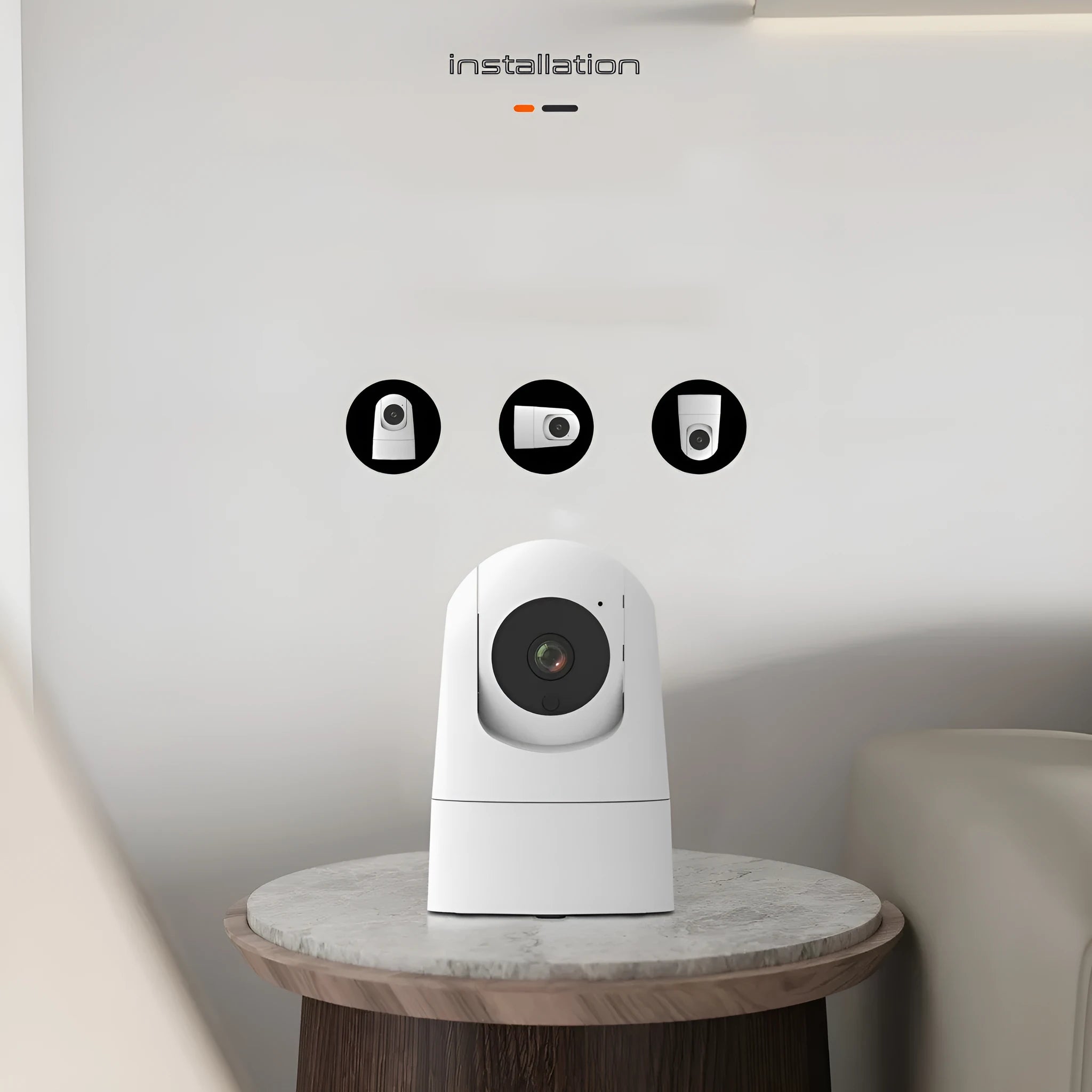 White indoor security camera with wide-angle lens on a shelf, showing companion app on a mobile phone.