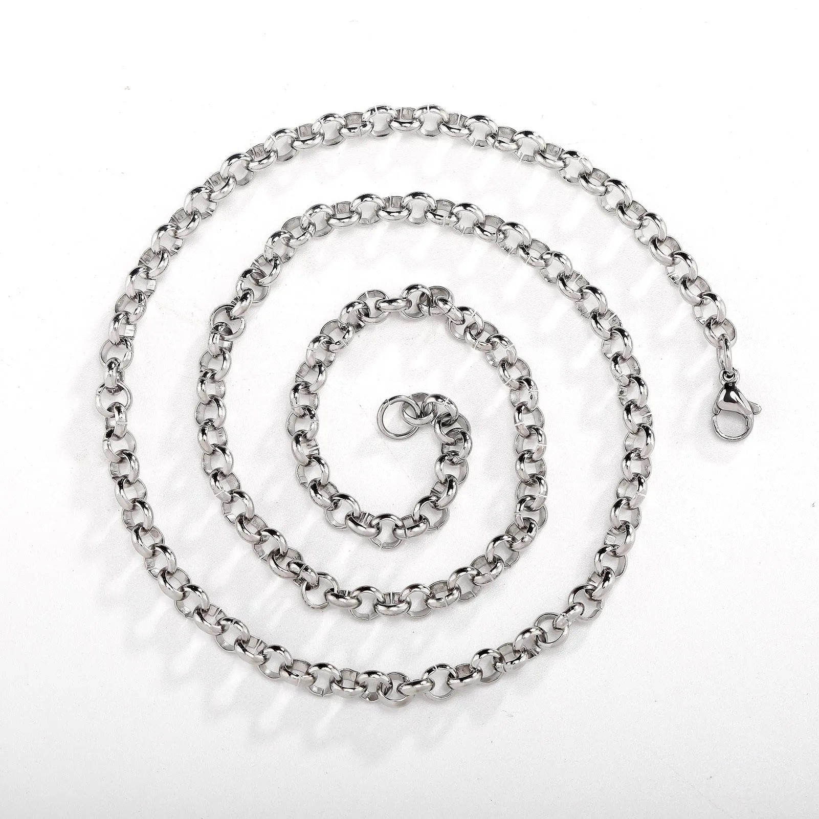 Silver stainless steel men's punk ring buckle necklace with O-ring chain and copper zircon pendant on display