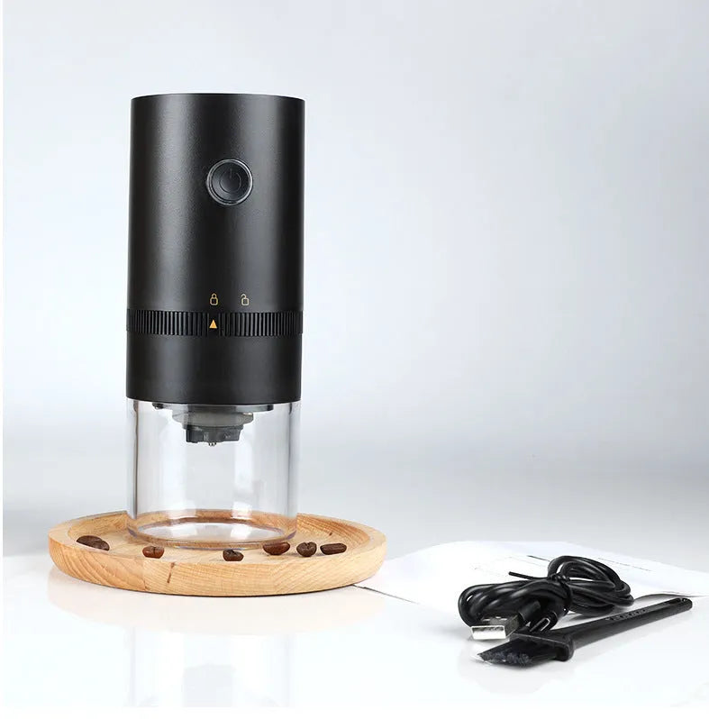 Portable black electric coffee grinder with transparent chamber and USB-C charging cable