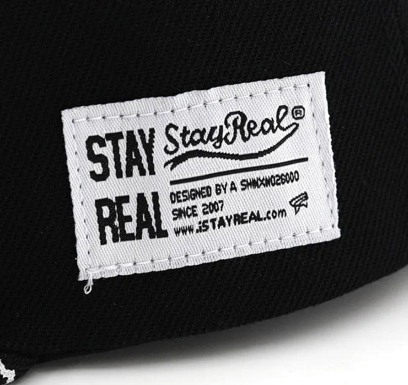 Adjustable black cotton baseball cap with embroidered lettering on the front, showing dome crown shape.