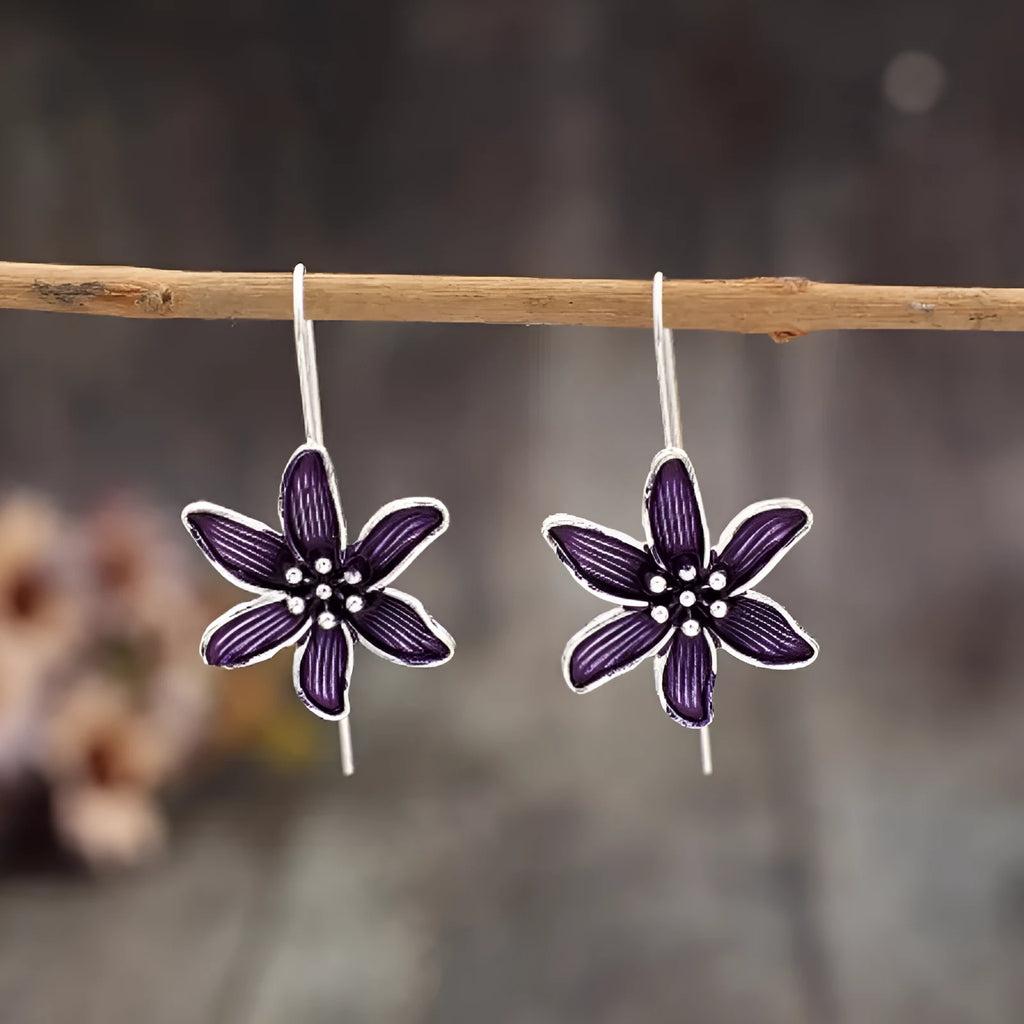 A pair of purple flower-shaped alloy earrings with a retro elegant design.