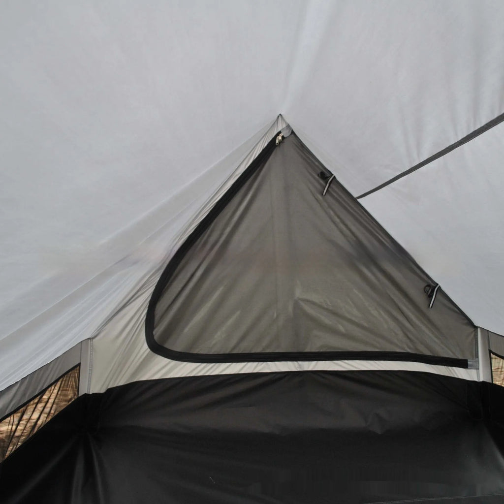 Brown A-line hiking tent pitched using trekking poles with guy ropes secured