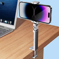 Silver aluminium alloy portable foldable clip lazy phone holder on a desk