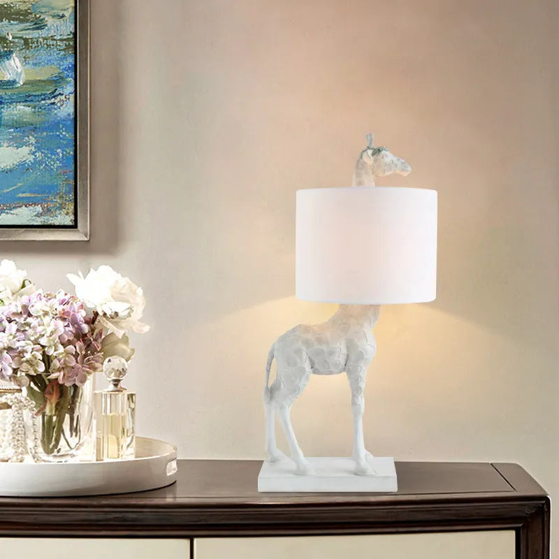 Giraffe table lamp with 66cm height in gold or white finish for bedside and desk lighting